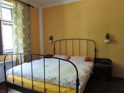 a bedroom with a bed with a bed frame and a window at Dům u rybníka in Nýdek