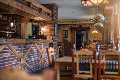 a room with a brick wall and a table and chairs at U Matyase in Stod