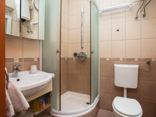 a bathroom with a shower and a toilet and a sink at Studio Ami in Zagreb