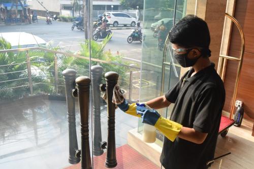 a man in a mask and gloves working on a pole at Sotis Residence Pejompongan in Jakarta