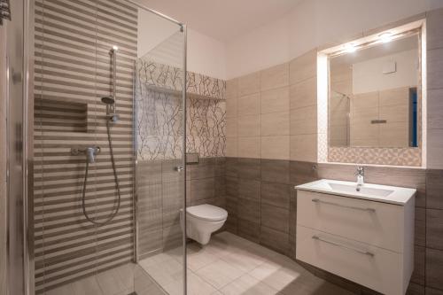een badkamer met een douche, een toilet en een wastafel bij Pablo in Niechorze