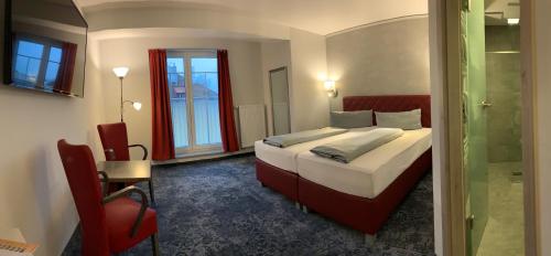 a bedroom with a bed and a glass door at Meister BÄR HOTEL Fichtelgebirge in Marktredwitz