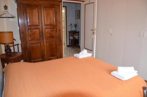 a bedroom with a bed with two towels on it at B&B Villa Olmo in Como