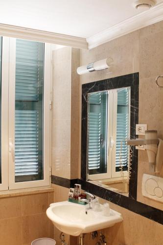 a bathroom with a sink and a mirror at Boutique Hotel Trevi in Rome