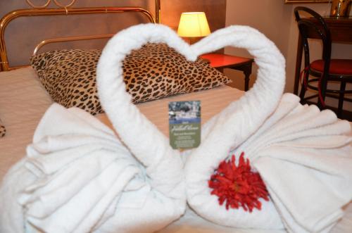 a bed with a heart made out of towels at B&B Villa Olmo in Como