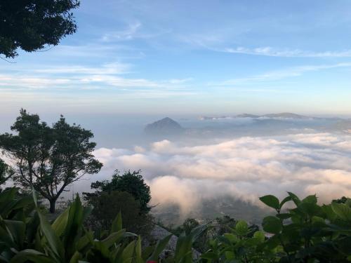 a view from the top of a mountain with clouds at Hotel Villa San Giovanni in Erice