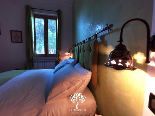 Letto o letti in una camera di La Suscella Bed & Breakfast