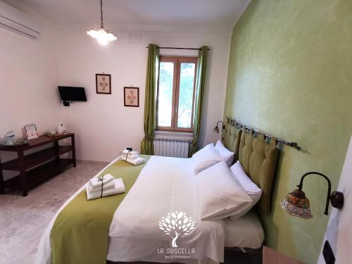 Letto o letti in una camera di La Suscella Bed & Breakfast