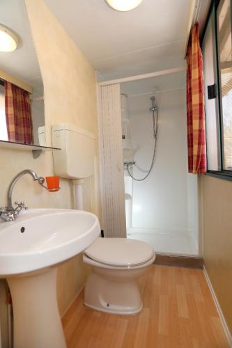 a bathroom with a toilet and a sink and a shower at Olive garden mobil home - Trogir in Trogir