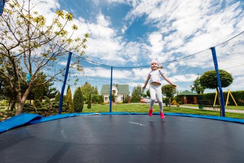 a young girl standing on a trampoline at Рестпарк рекреаційний комплекс in Luts'k