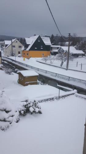 a train station with snow on the ground at Ferienwohnung Liebscher in Sehmatal