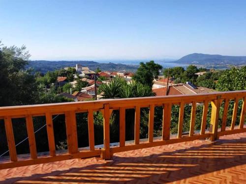 a wooden deck with a view of a town at Lefkada Villas Panoramic in Katouna