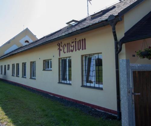 a building with a sign on the side of it at Penzion Štekrův Mlýn in Františkovy Lázně