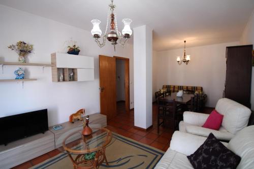 a living room with a couch and a table at Foz Beach House in Buarcos