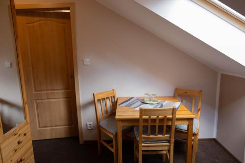 a dining room with a wooden table and chairs at Penzion Štekrův Mlýn in Františkovy Lázně