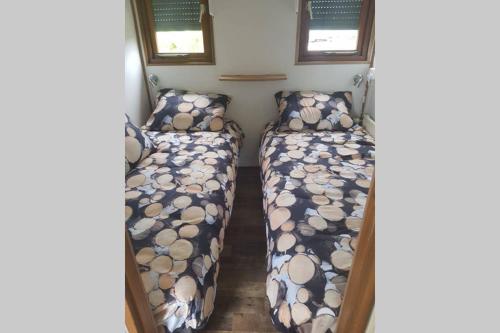 a bedroom with two beds in a small room at Stuyvesanthof scheldeoord chalet 710 in Baarland