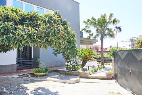 a building with trees and flowers in a courtyard at Una Chicca a Roma in Rome