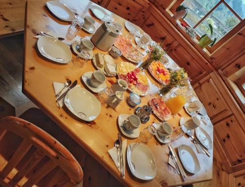 a table with plates of food on top of it at Gästehaus Laßnig in Ebene Reichenau