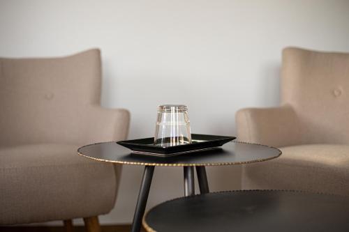 a coffee table with a glass on top of it at Hotel Sonne Garni in Hinterzarten