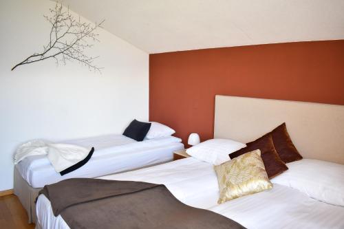 two beds in a hotel room with white sheets at Hostellerie d'Orzival in Vercorin