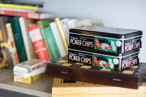 two boxes of root chips sitting on a shelf next to books at Good People Design Hostel in Belgrade