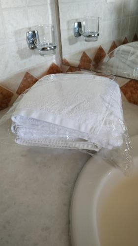 a toilet with a plastic cover on top of it at Village Villas in Lygia