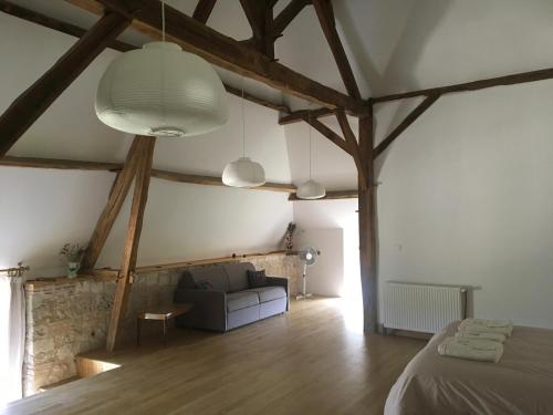 une chambre avec un lit et un canapé dans une pièce dans l'établissement Chambre d'Hotes Cugnac, à Sainte-Sabine
