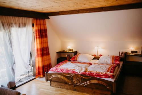 a bedroom with a bed and a large window at Ferienwohnung Vidmar in Arriach