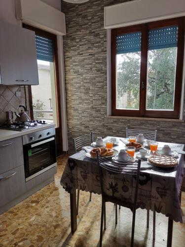 a kitchen with a table with food on it at App.Violet Sardegna Mare La Caletta in La Caletta
