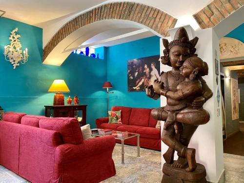 a statue of a woman holding a child in a living room at Hotel Il Guercino in Bologna