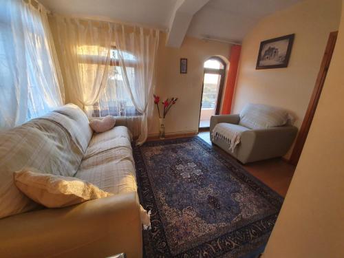 a living room with a couch and a chair at Villa Camelia in Tuzla