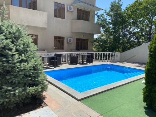 a swimming pool in front of a house at Capital Hotel in Yerevan