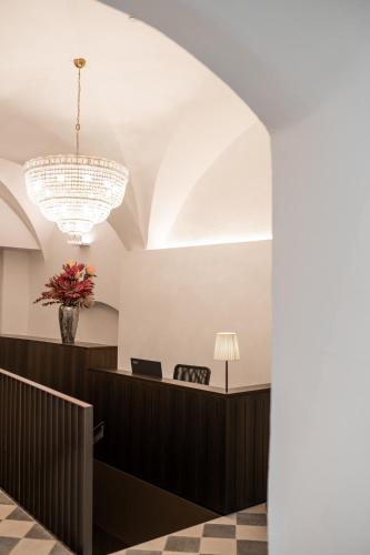 a view of a waiting room with a chandelier at Kuntino Suites in Merano