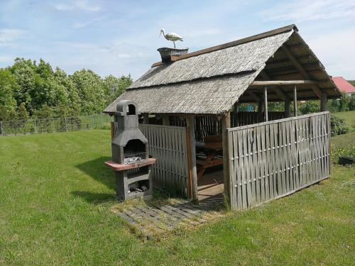 a building with a bird sitting on top of it at Niebieska Tawerna in Węgorzewo