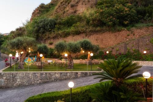 a group of street lights in front of a mountain at La Risacca Relais in Belvedere Marittimo
