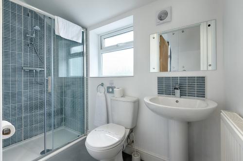 een badkamer met een toilet, een wastafel en een douche bij The Old Bakery - TV in Every Bedroom! in Swansea
