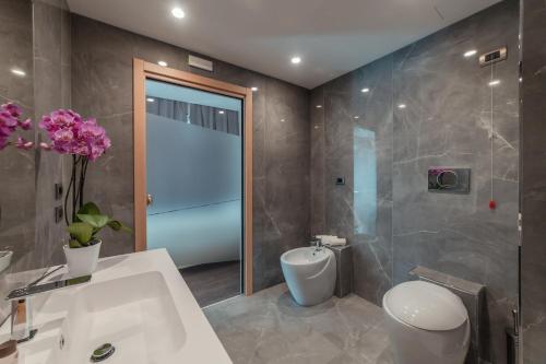 a bathroom with a sink and a toilet and a shower at Hotel Continental in Taormina