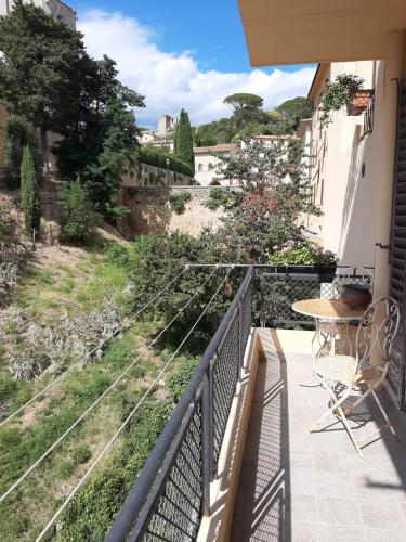 a balcony with a table and a view of a street at AL 32 B&B in Massa Marittima