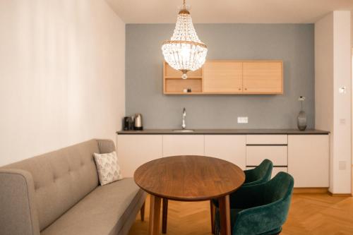 a living room with a couch and a table at Kuntino Suites in Merano