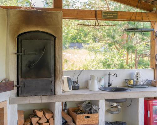 a kitchen with a counter with a sink in it at Uue-Hallikivi Talu in Malvaste