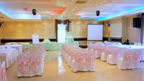 a room with white tables and chairs with pink bows at ESTRADA Lux in Belgrade