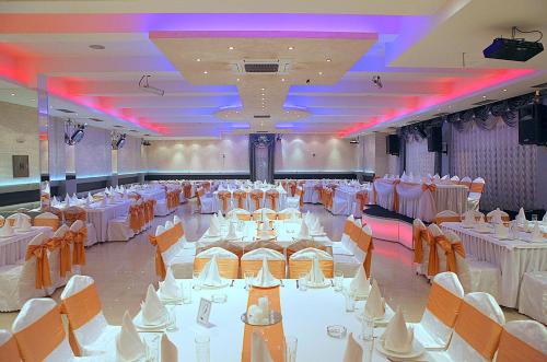a banquet hall with white tables and chairs at ESTRADA Lux in Belgrade