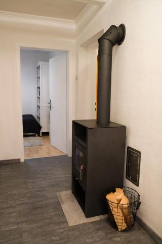a black stove in a room with a hallway at Apartment Danielsbergblick in Napplach