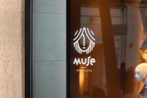 a sign on a glass door of a building at Muse Urban Suites in Athens
