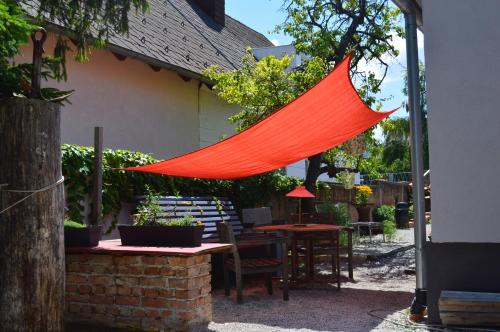 an orange hammock hanging from the side of a patio at Das Nest in Eisenstadt