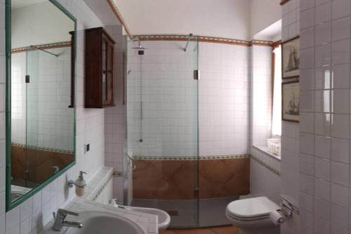 a bathroom with a shower and a toilet and a sink at VelaLatina Residence B&B Soverato in Soverato Marina