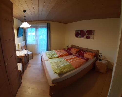 a bedroom with a bed and a desk in it at Ferienwohnung Schönauer in Haus im Ennstal
