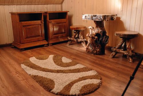 a room with a rug on a wooden floor at Villa Nikoletta SPA in Bukovel