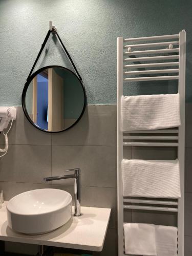 a bathroom with a sink and a mirror at Delta Park in Porto Viro