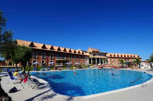 a large swimming pool in front of a hotel at Corte dei Greci Resort & Spa in Cariati